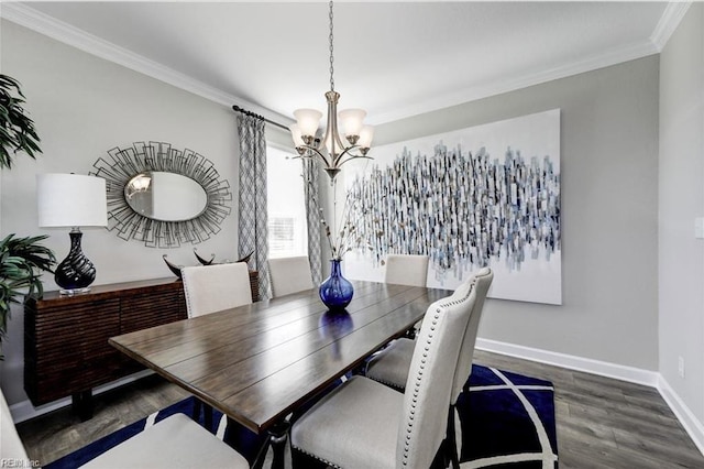 dining room with dark hardwood / wood-style floors, crown molding, and an inviting chandelier