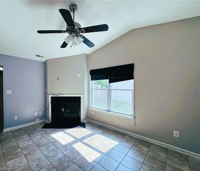 unfurnished living room with a textured ceiling, ceiling fan, tile patterned floors, and lofted ceiling