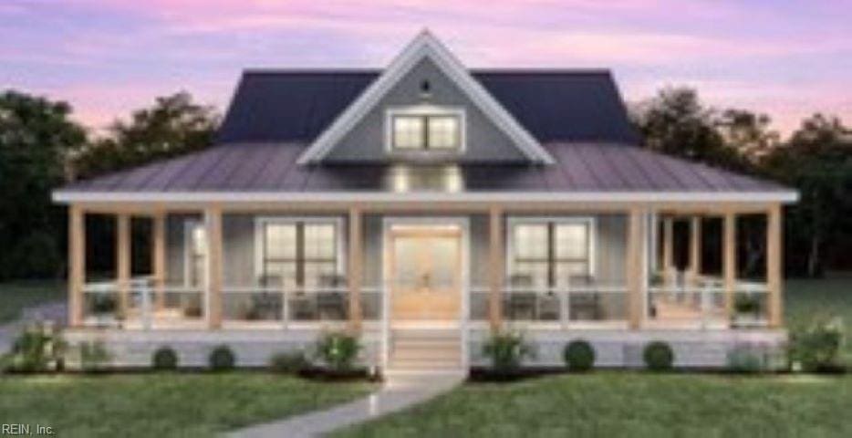 view of front facade with a yard and covered porch