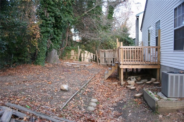 view of yard featuring a deck and central AC unit