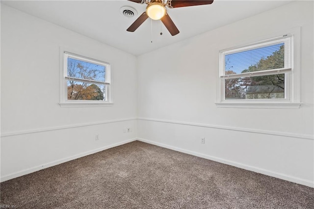 empty room with carpet, ceiling fan, and a healthy amount of sunlight