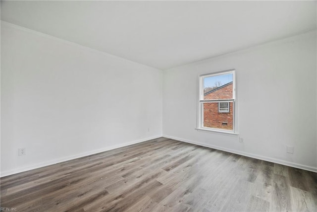 unfurnished room with hardwood / wood-style flooring