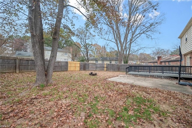 view of yard with a patio area and a wooden deck