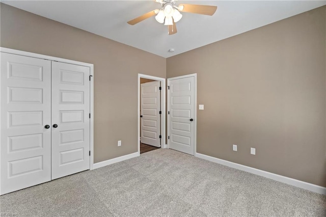 unfurnished bedroom with carpet flooring, ceiling fan, and a closet