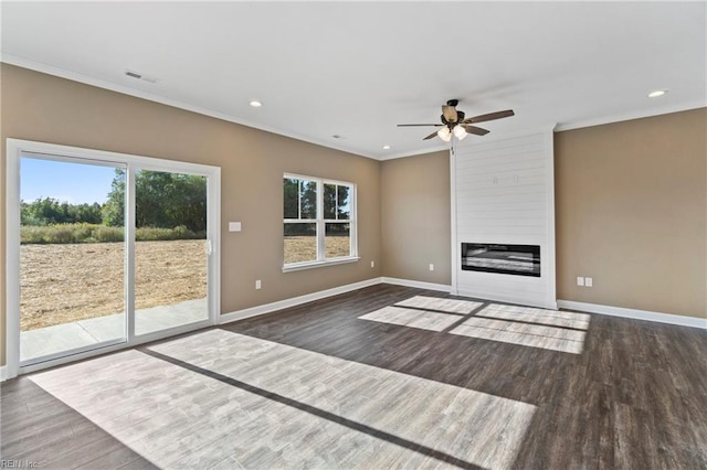 unfurnished living room with crown molding, a fireplace, ceiling fan, and dark wood-type flooring