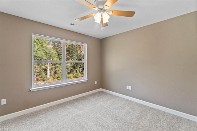 spare room featuring carpet flooring and ceiling fan