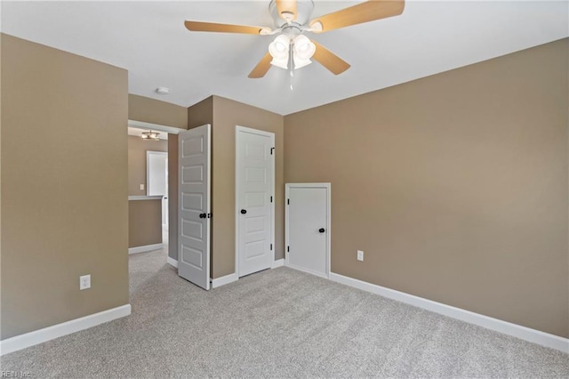 unfurnished bedroom featuring ceiling fan and light colored carpet