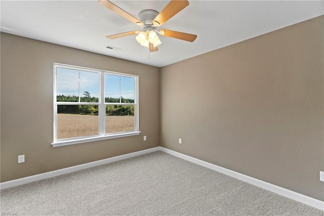 empty room with ceiling fan and carpet