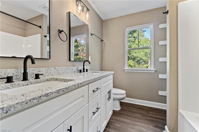 bathroom with hardwood / wood-style floors, vanity, and toilet