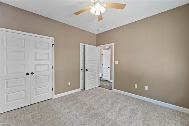 unfurnished bedroom with carpet flooring, ceiling fan, and a closet