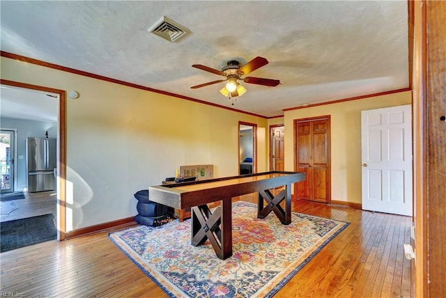 game room with ceiling fan, pool table, wood-type flooring, and ornamental molding