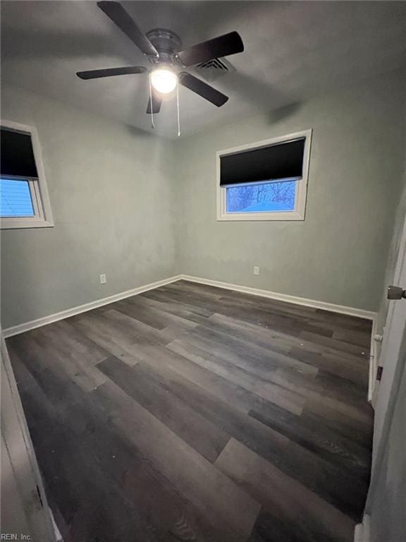 unfurnished bedroom with ceiling fan, visible vents, baseboards, and wood finished floors