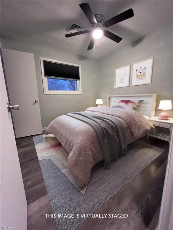 bedroom featuring a ceiling fan, wood finished floors, and visible vents