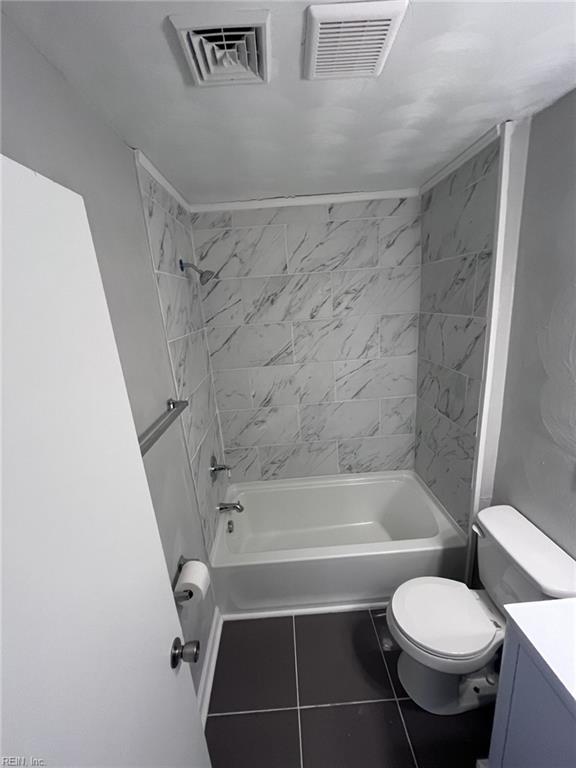 bathroom featuring toilet, washtub / shower combination, and visible vents