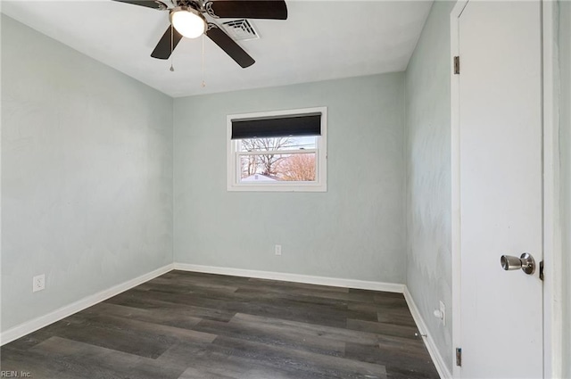 spare room with a ceiling fan, wood finished floors, and baseboards