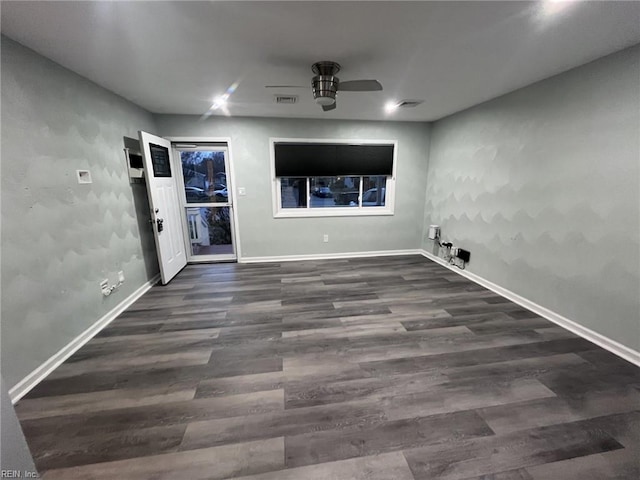 interior space featuring ceiling fan and dark wood-type flooring