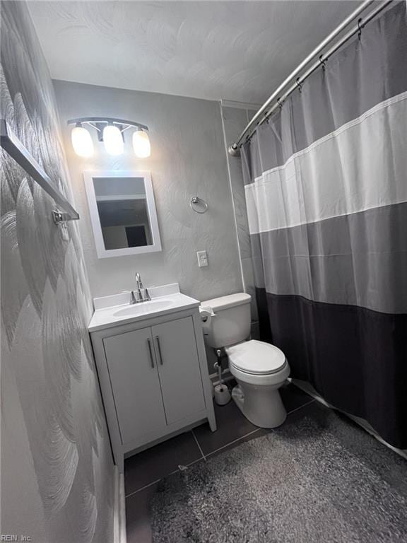 full bath featuring curtained shower, toilet, vanity, and tile patterned flooring