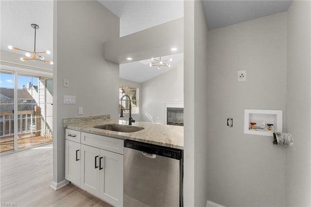 kitchen featuring dishwasher, plenty of natural light, white cabinetry, and sink