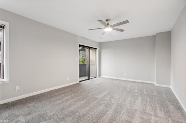 empty room with ceiling fan and carpet