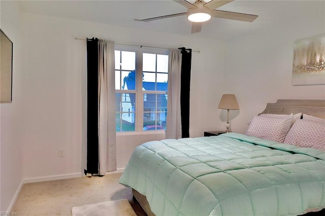 bedroom featuring ceiling fan and light carpet