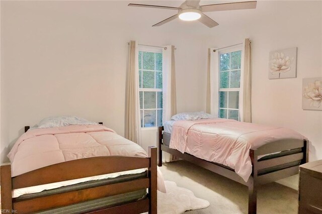 bedroom with carpet flooring, multiple windows, and ceiling fan