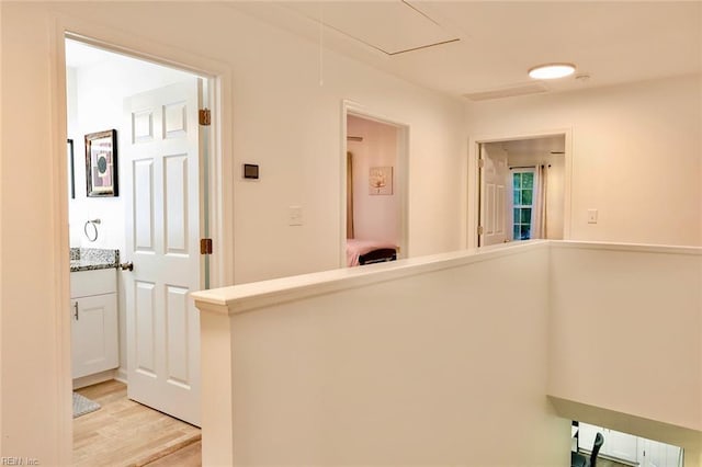 corridor with light hardwood / wood-style flooring