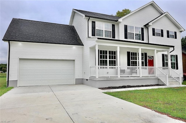 view of front of home featuring covered porch, a garage, and a front lawn