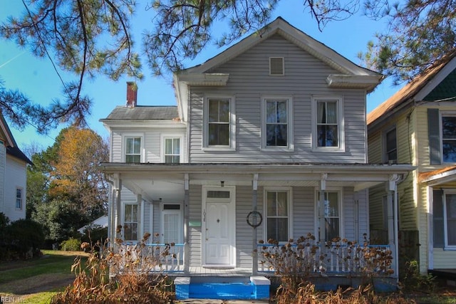 view of front of house with a porch and a chimney