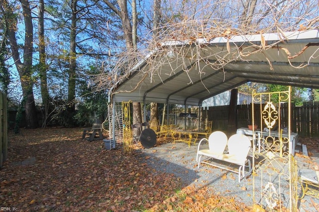 exterior space with a carport and fence