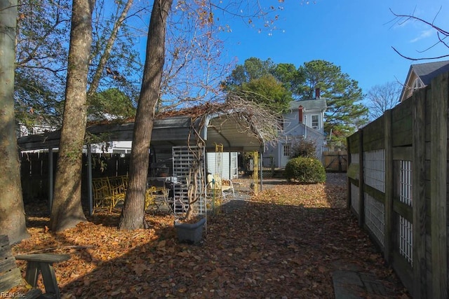 view of side of home featuring fence