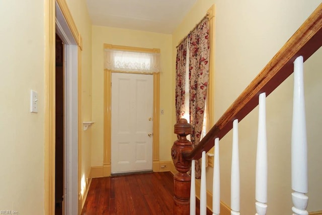 entrance foyer featuring dark wood finished floors and stairway