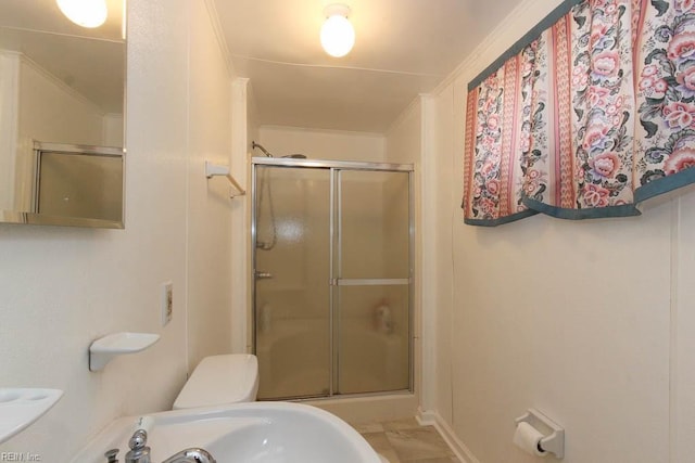 bathroom featuring toilet and a stall shower