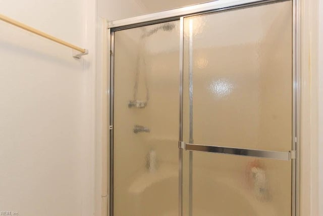 full bath with a shower with shower door