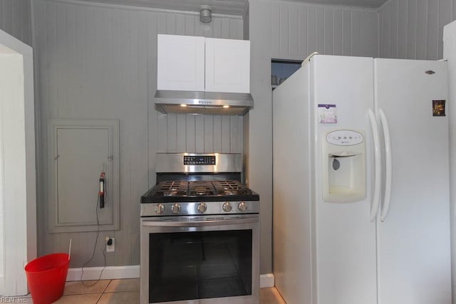 kitchen with under cabinet range hood, white fridge with ice dispenser, light tile patterned floors, and gas stove