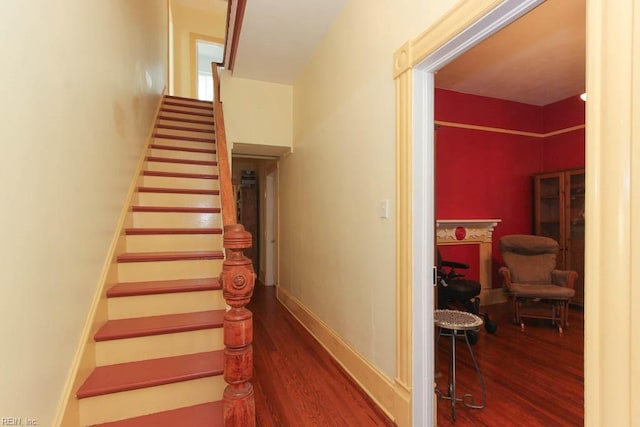 stairs with wood finished floors and baseboards