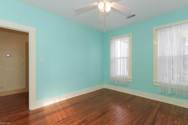 unfurnished room featuring visible vents, ceiling fan, baseboards, and wood finished floors