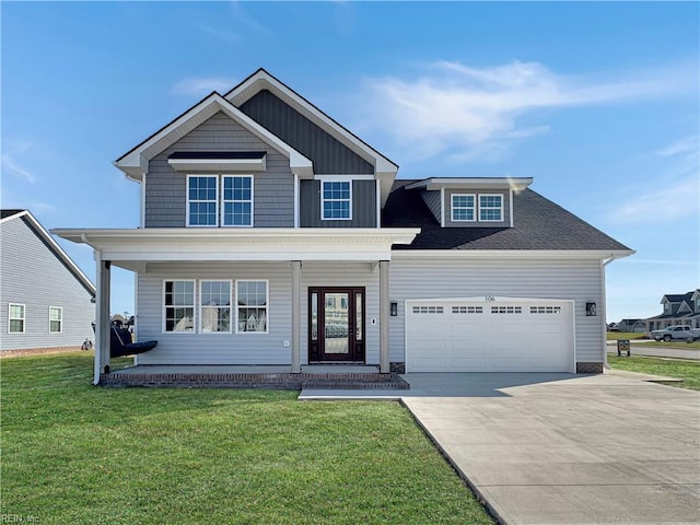 view of front of house with a front yard and a garage