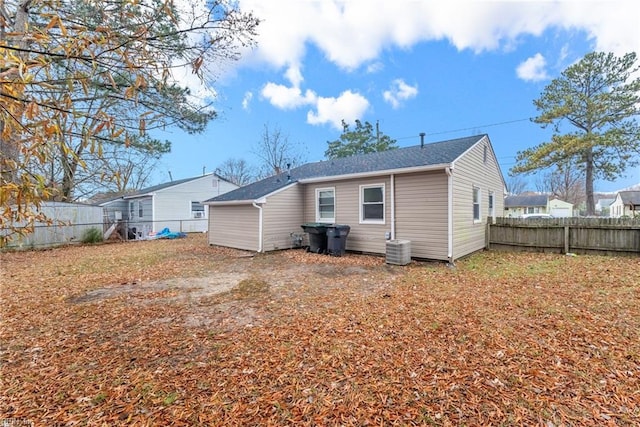 rear view of house featuring central AC unit