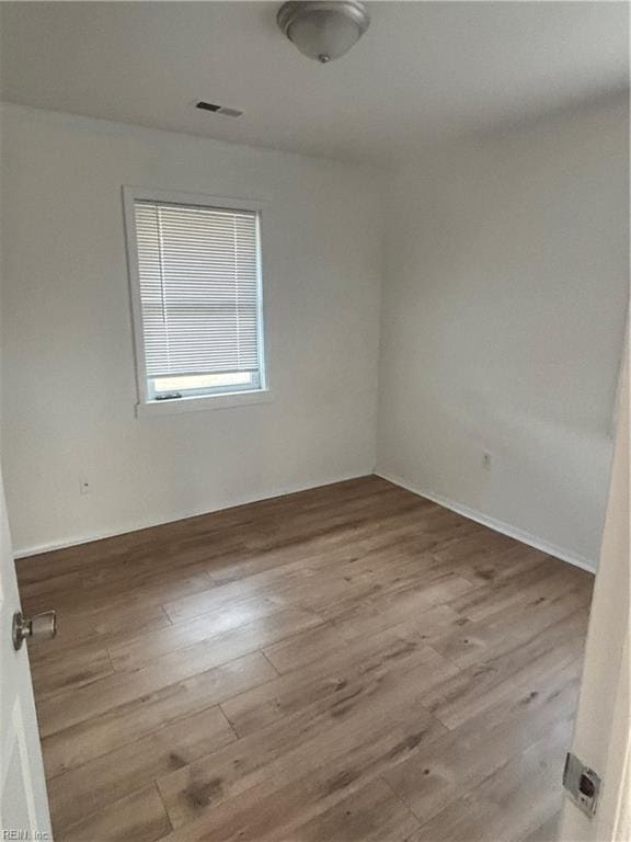 unfurnished room with light wood-type flooring