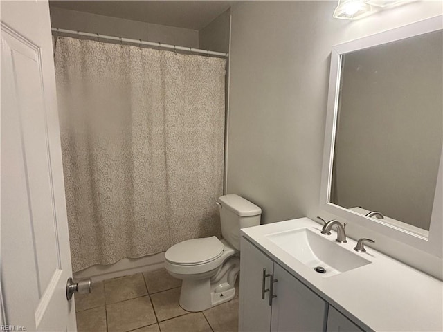 bathroom featuring tile patterned floors, vanity, and toilet