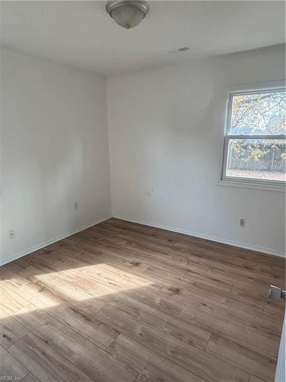 spare room with light wood-type flooring