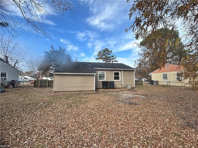 back of house with central AC unit