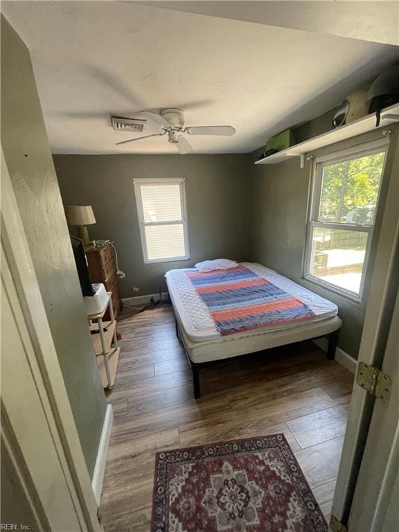 bedroom featuring hardwood / wood-style flooring and ceiling fan