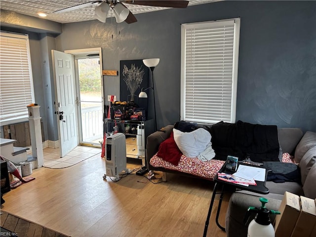 living room featuring ceiling fan and light hardwood / wood-style floors