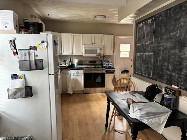 kitchen with white cabinets, white appliances, and light wood-type flooring