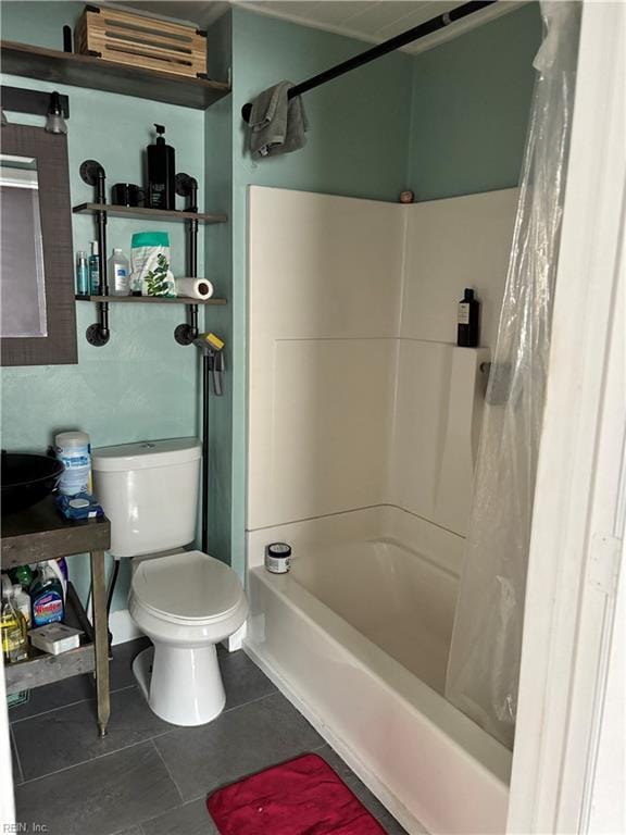 bathroom with shower / bathtub combination with curtain, tile patterned floors, and toilet