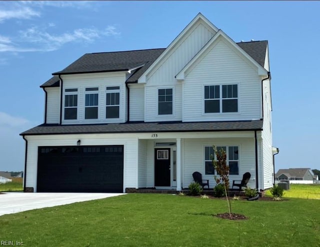 view of front of home featuring a garage and a front lawn