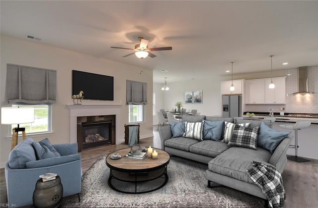 living room featuring hardwood / wood-style floors and ceiling fan