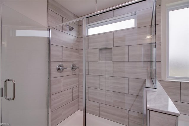 bathroom featuring a shower with shower door