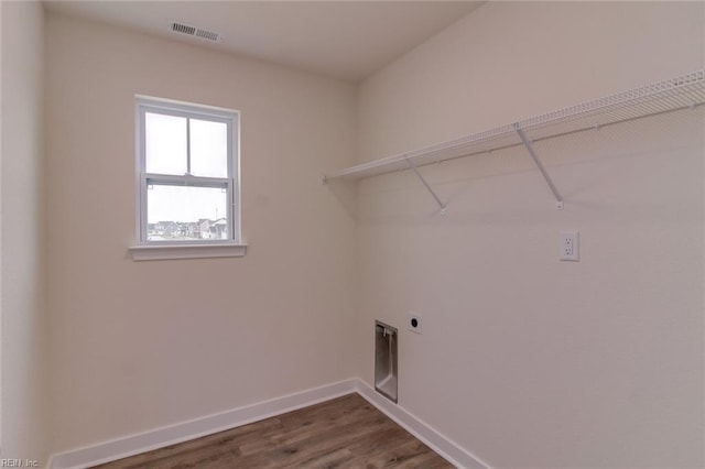 laundry area featuring hookup for an electric dryer and hardwood / wood-style flooring